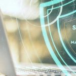 Image of a digital shield with the words 'Scanning for malware...' over a laptop computer.